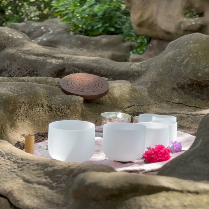 Bowls nestled among rocks and flowers
